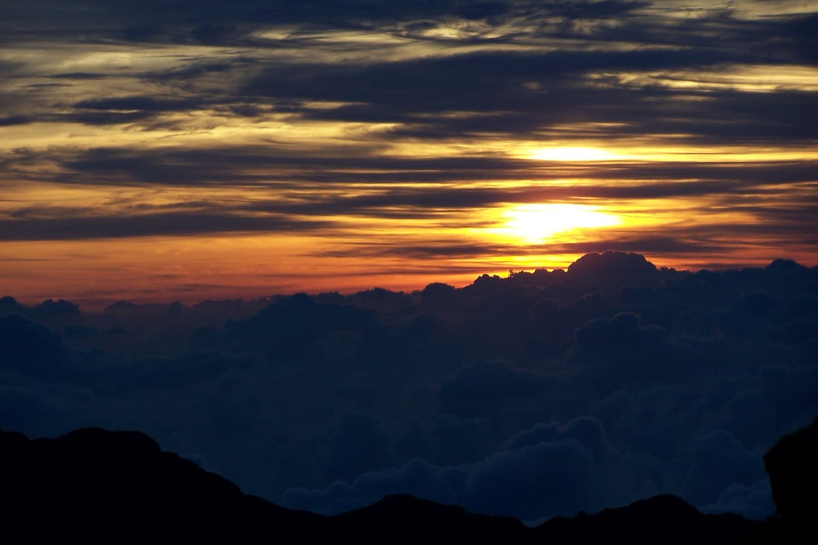 Sunrise above clouds from the summit of Haleakala in Maui