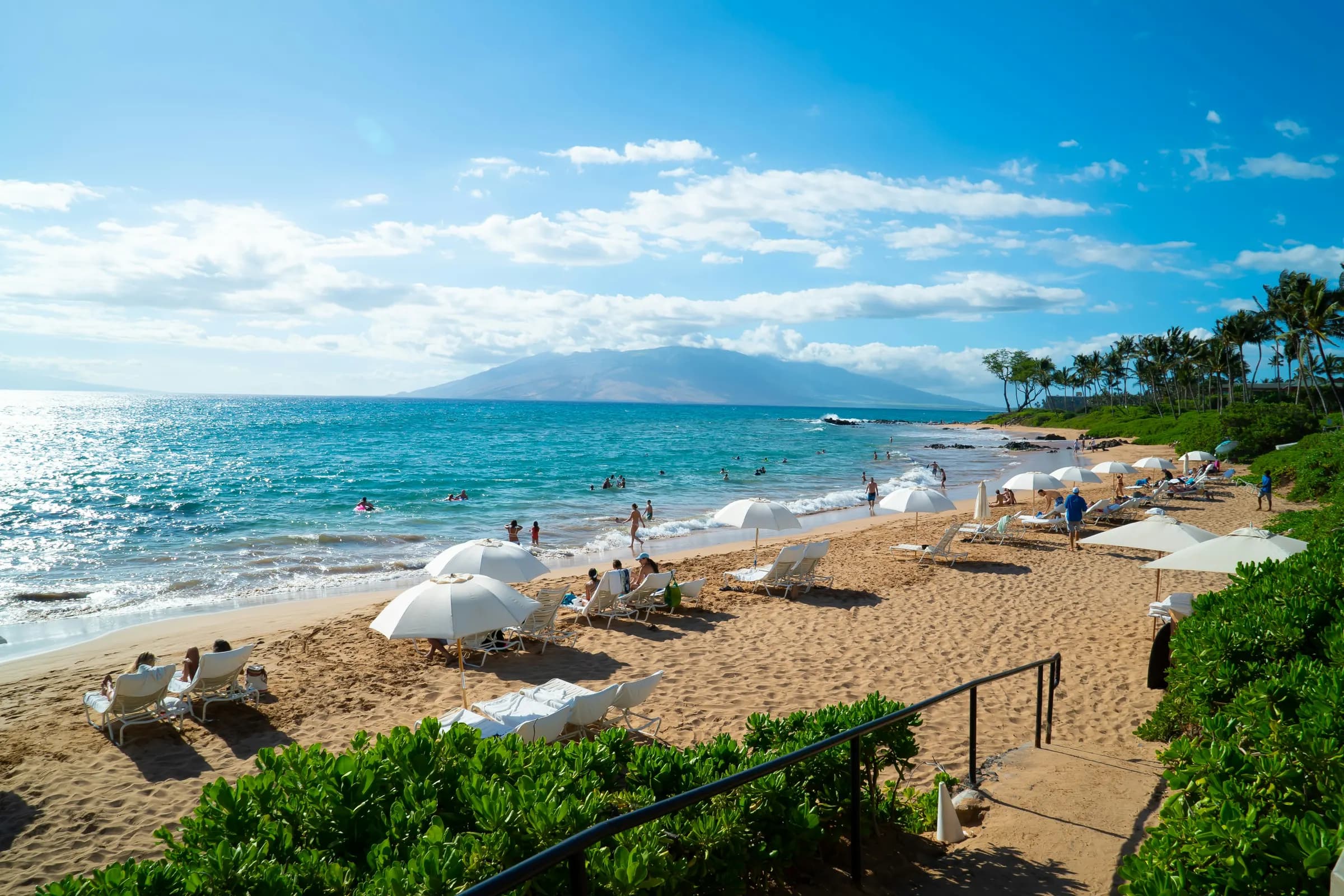 Beach umbrellas on a Maui shoreline near Kahului