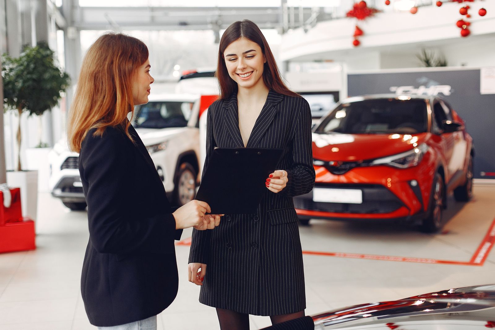 Customer reviewing vehicle paperwork at a car counter