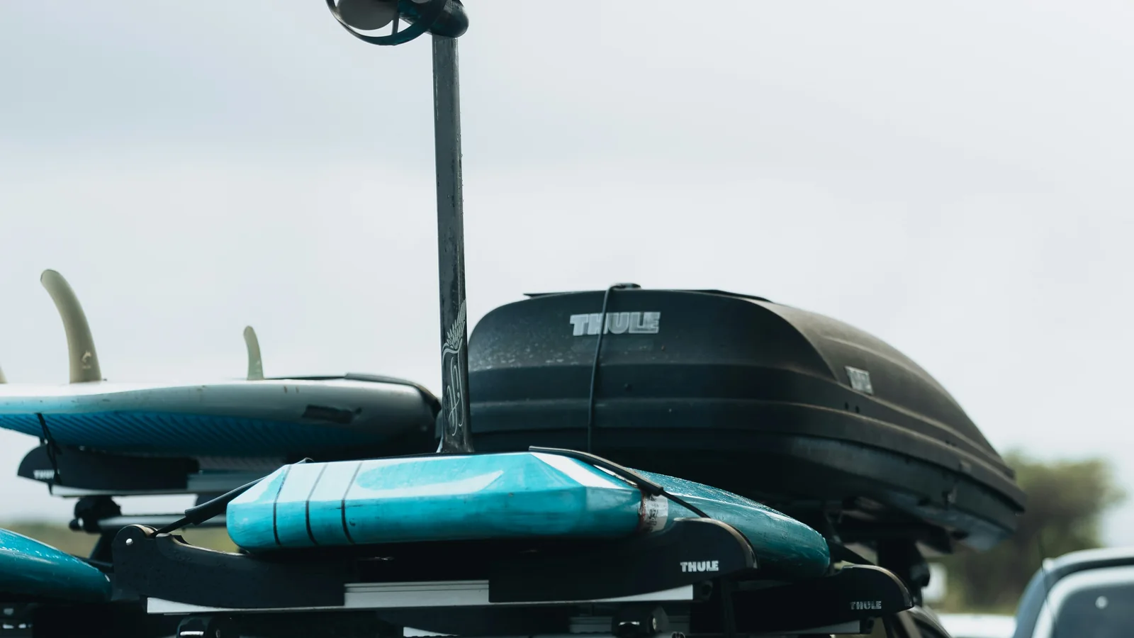 Surfboards and hydrofoil gear secured on a truck rack in Maui